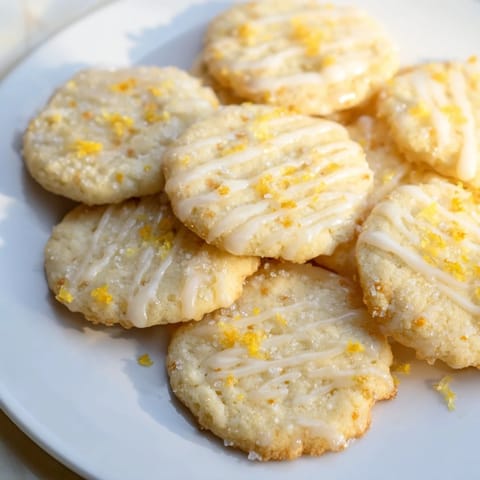 Freshly baked Lemon Sugar Cookies with a bright citrus glaze, perfect for dessert with a friend.