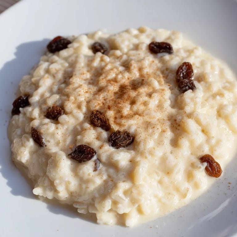 A baking dish filled with golden-brown rice pudding, topped with a dusting of nutmeg, ready to serve.