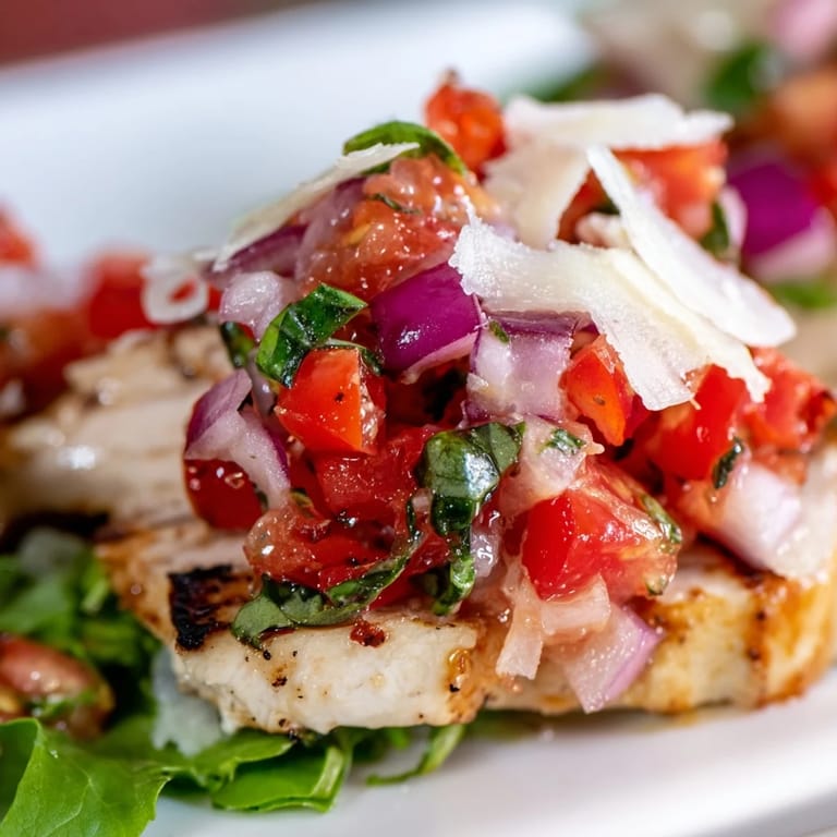 Serve this vibrant Bruschetta Chicken Salad with lemon wedges on the side for a light and flavorful summer dinner.
