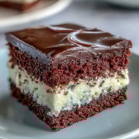 A close-up shows the Red Betty Boop Heart Cake slice with soft red crumb and velvety cream cheese frosting.