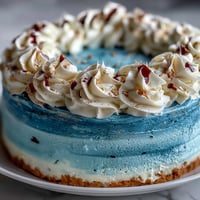 Graduation cake with dark blue and gold ombre layers, elegantly frosted and ready for celebration.